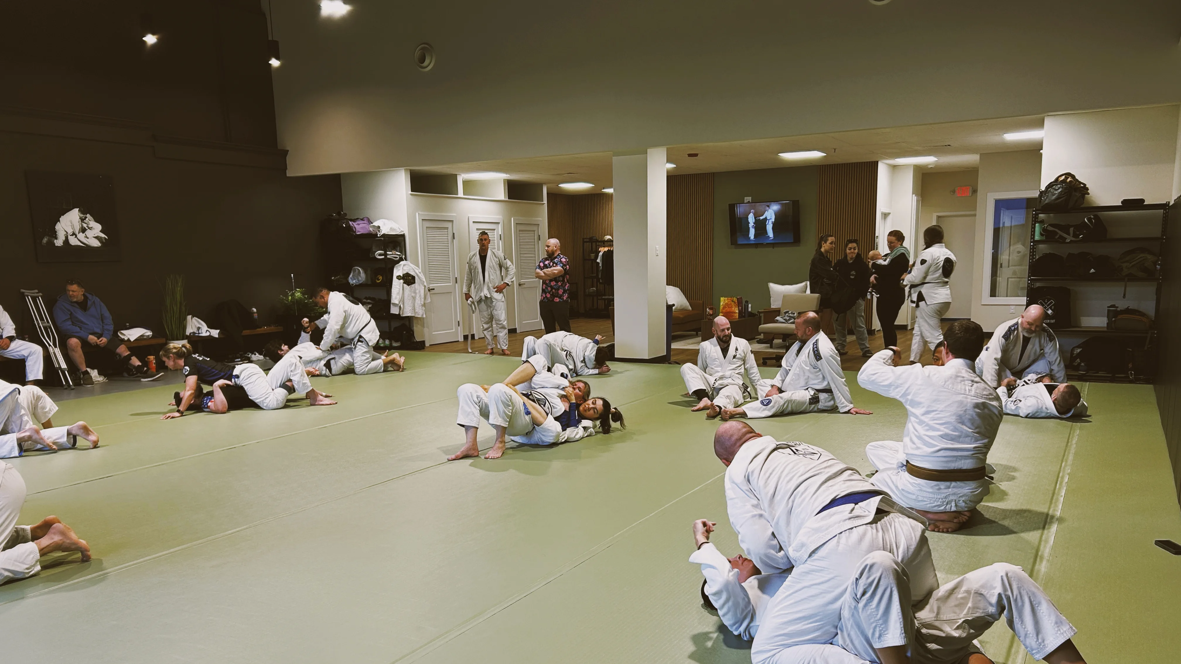 A full Master Cycle open mat session with students drilling across the academy floor.