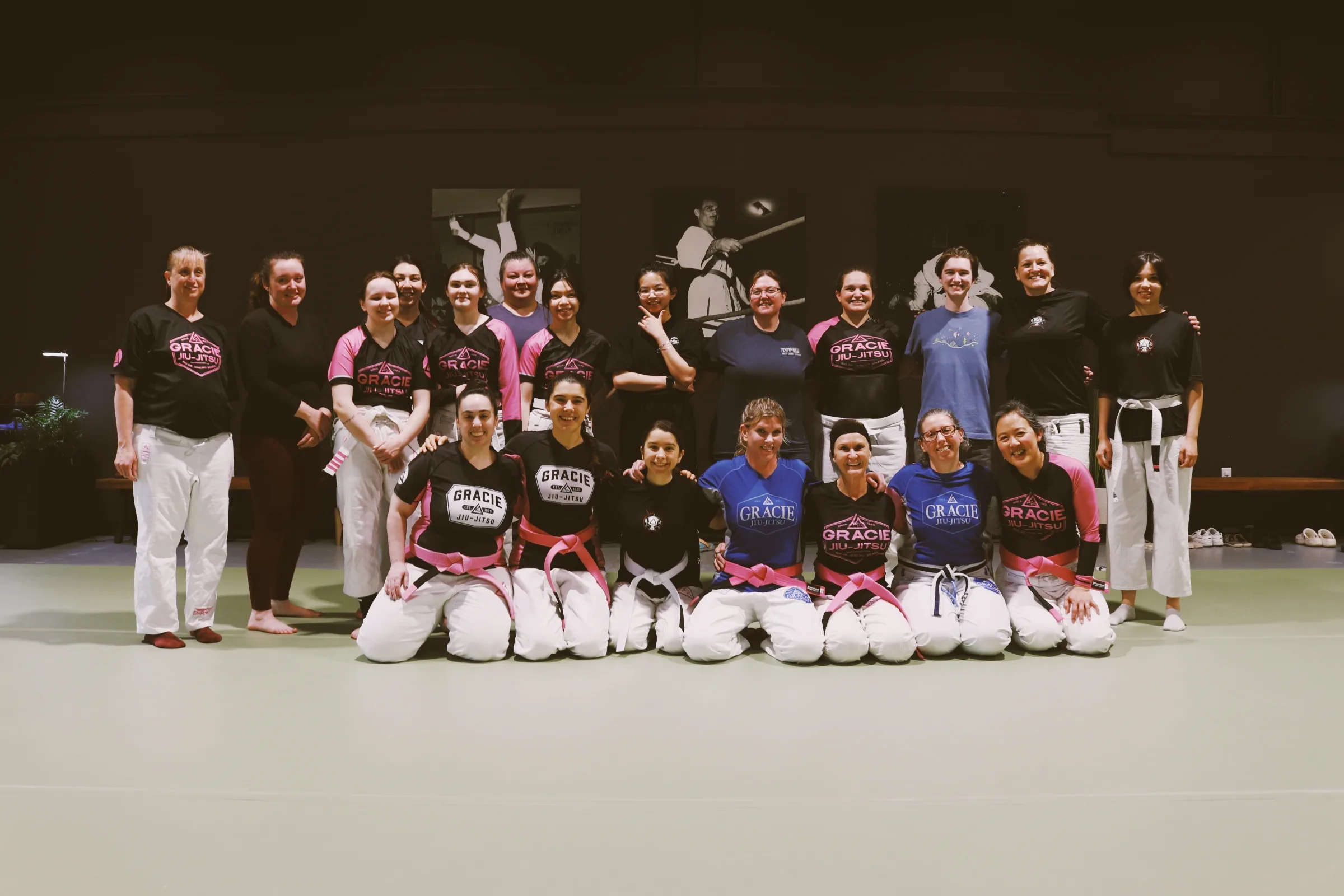 The Women Empowered class gathered together for a group photo on the mat.